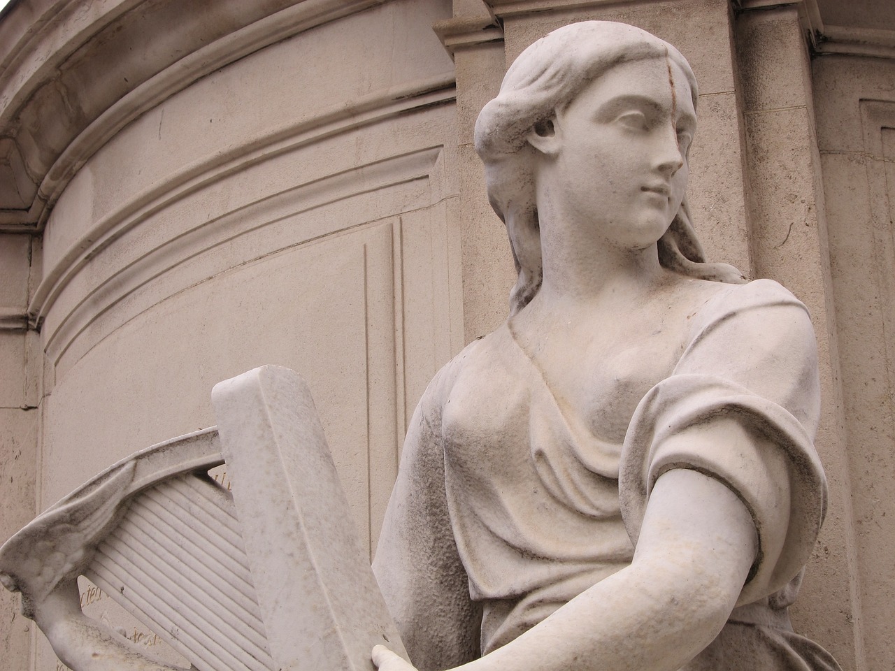 a statue of a woman holding a harp, inspired by Antonio Canova, flickr, over-shoulder shot, detailed classical architecture, joan of arc, half - length photo