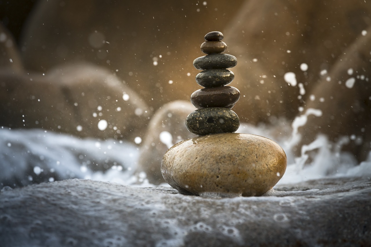 a stack of rocks sitting on top of a body of water, by Matthias Weischer, wave of water particles, zen temple background, fine detail post processing, miniature product photo