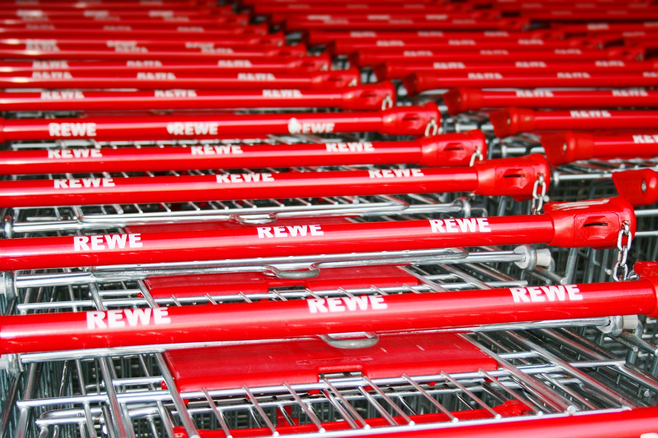 a row of red shopping carts sitting next to each other, a picture, inspired by Jürg Kreienbühl, rudolf weisse, beaver, detailed picture, exiting store