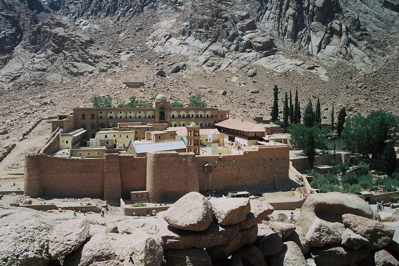 a large brown building sitting on top of a rocky hillside, a photo, flickr, les nabis, egyptian setting, orthodox, 1 9 9 8 photo, courtyard