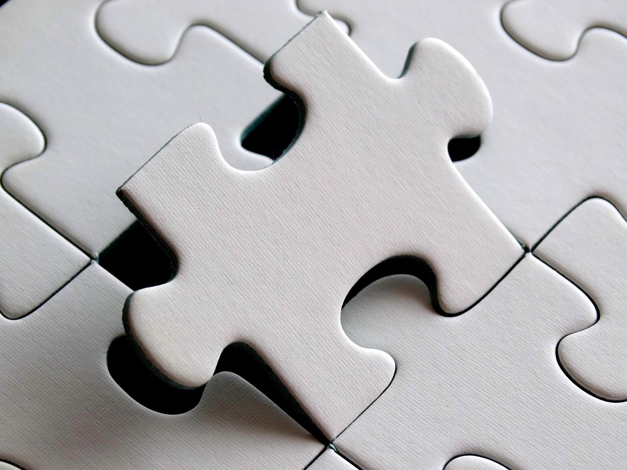a white puzzle piece laying on top of a table, precisionism, meticulous details, istockphoto, white mechanical details, mobile wallpaper