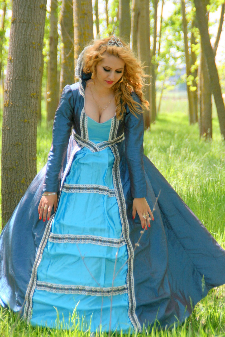 a woman in a blue dress in the woods, inspired by Arthur Hughes, rococo, fantasy leather clothing, photo 85mm, stylish coat for a rave, princess zelda