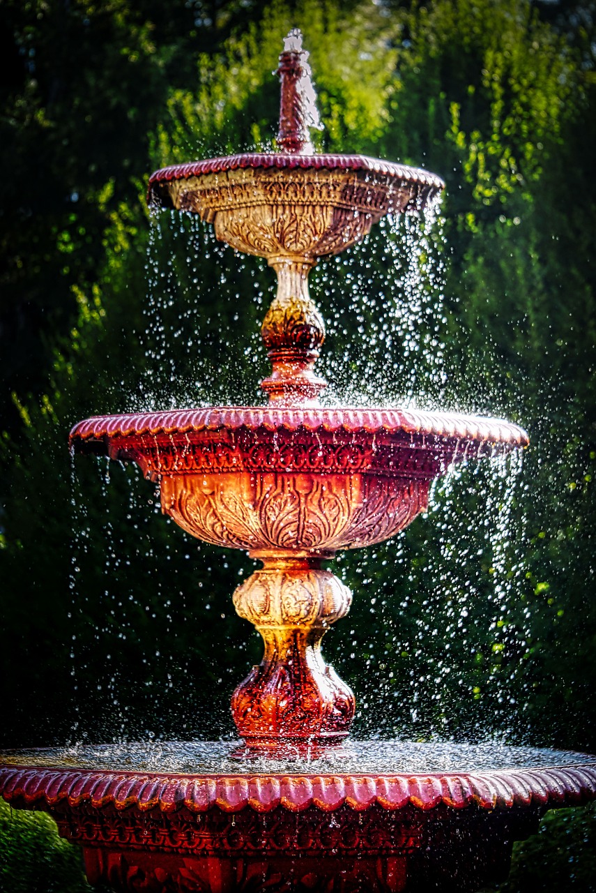 a water fountain in the middle of a park, inspired by Cherryl Fountain, art photography, red and golden color details, color ( sony a 7 r iv, “ golden chalice, stacked image