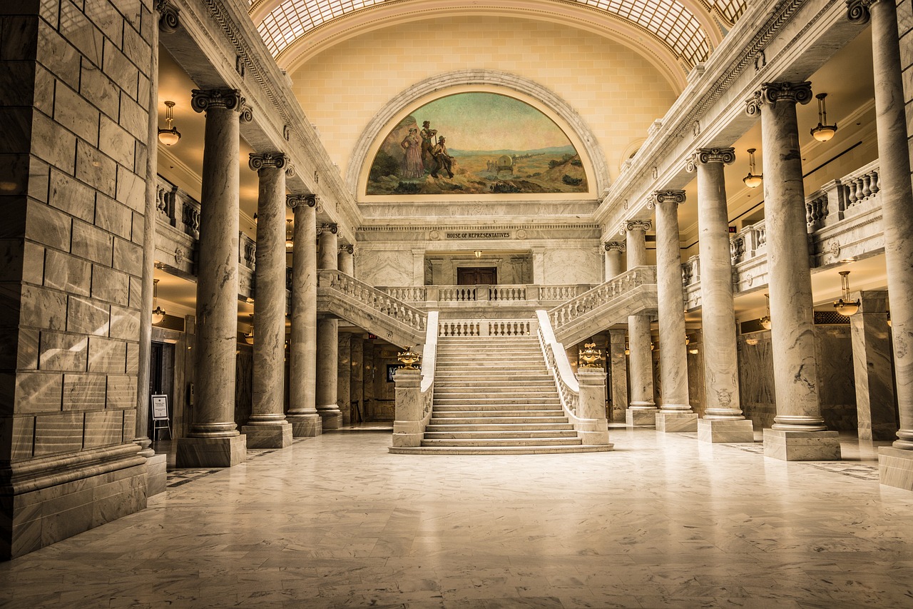 a staircase in a building with a painting on the wall, a matte painting, by Carl Rahl, shutterstock, gigantic pristine marble columns, idaho, official courthouse, unsplash contest winning photo