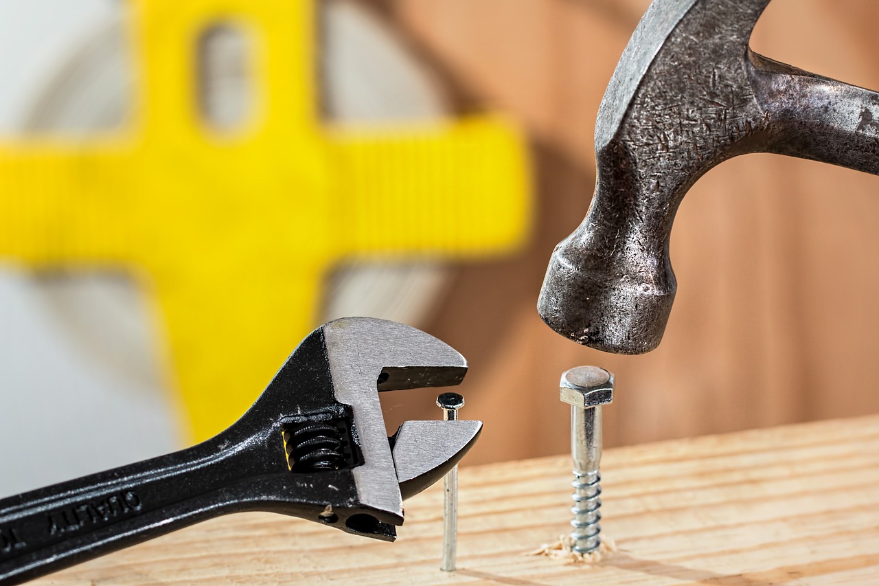 a hammer hitting a nail with a pair of pliers, a stock photo, by Alexander Fedosav, shutterstock, on a yellow canva, chunky build, close-up product photo, wooden