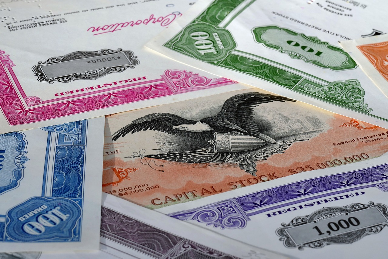 a pile of money sitting on top of a table, a stock photo, by Tom Carapic, art nouveau, eagle, various colors, trading stocks, high angle close up shot