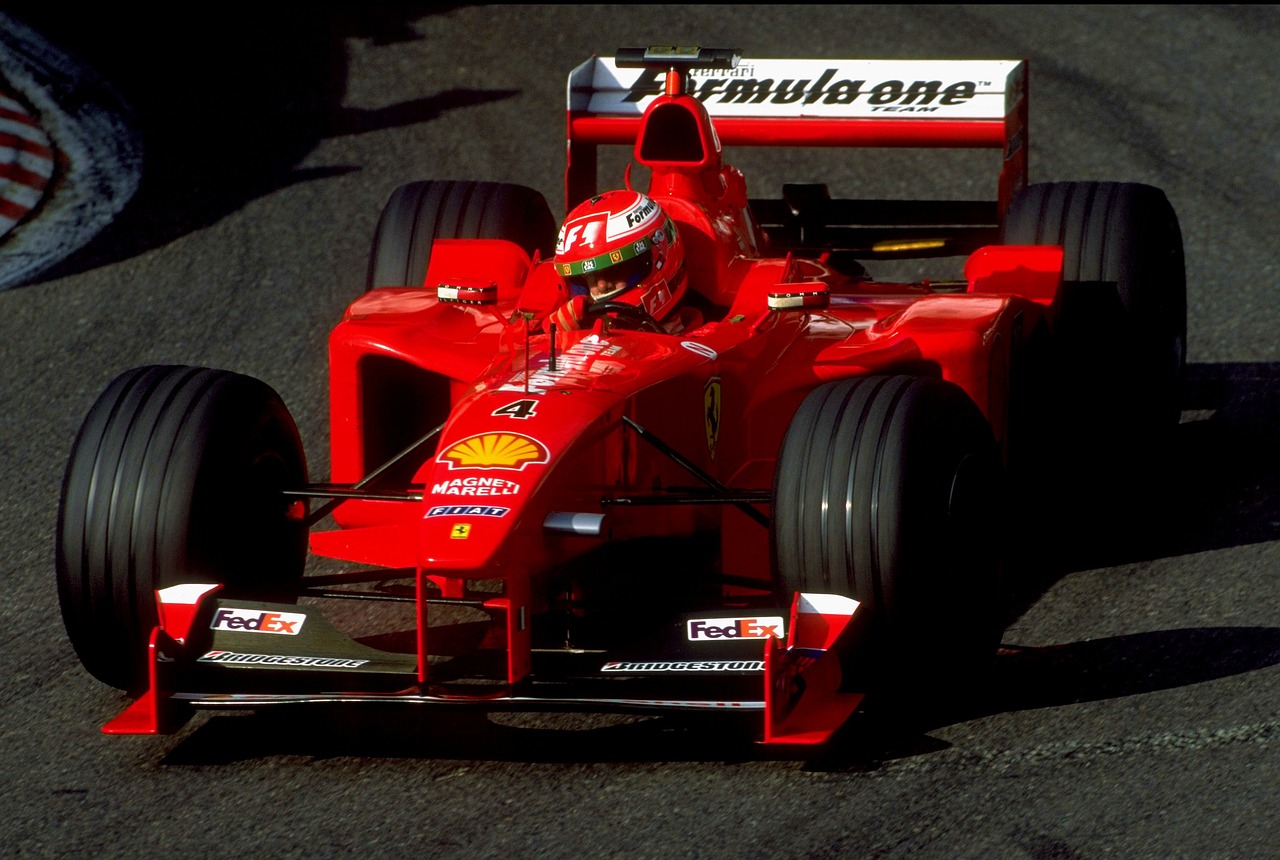 a man driving a red race car on a track, by Shigeru Aoki, monaco, in 1 9 9 5, wallpaper mobile, kimi vera