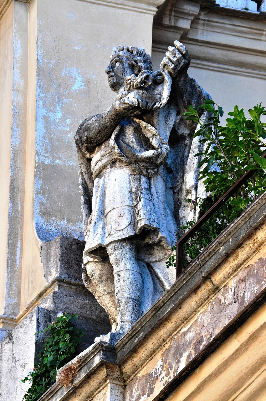 a statue that is on the side of a building, a statue, inspired by Girolamo Muziano, flickr, lviv historic centre, high detail!!!, dressed in a ragged, tomb