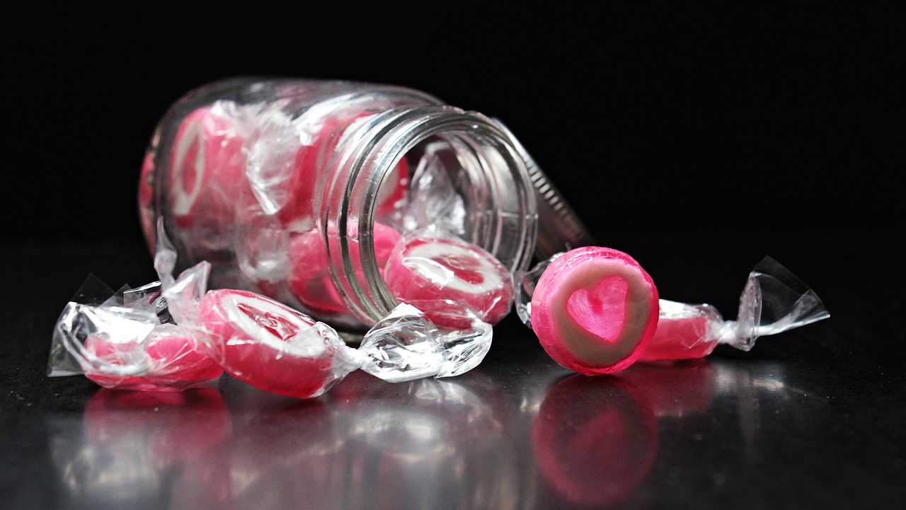 a jar filled with candy sitting on top of a table, by Lee Loughridge, pexels, hyperrealism, pink diamonds, jello, close up food photography, 240p