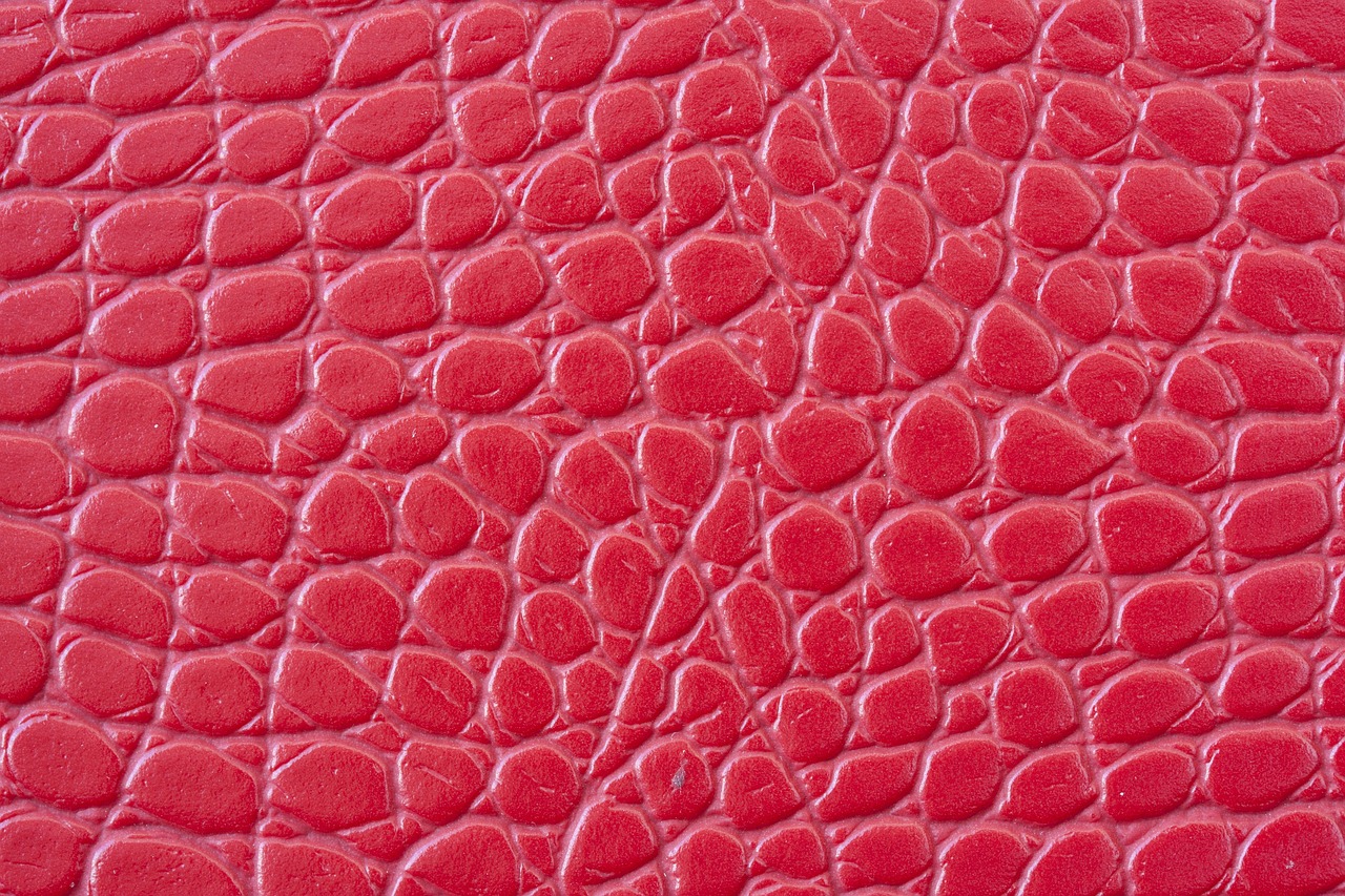 a close up of a red leather surface, a macro photograph, close-up product photo, rubber, highly detailed product photo, crackles