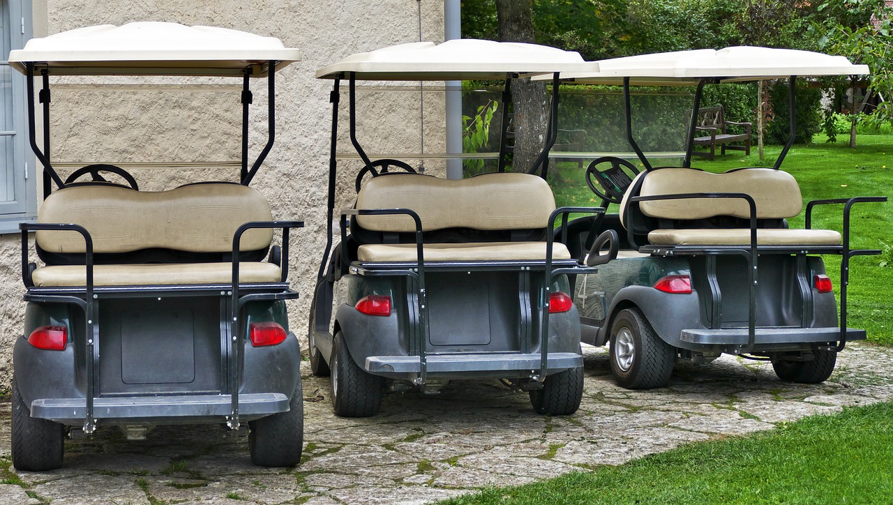 three golf carts parked in front of a house, shutterstock, stock photo, carriage full of computers, back - shot, pov photo