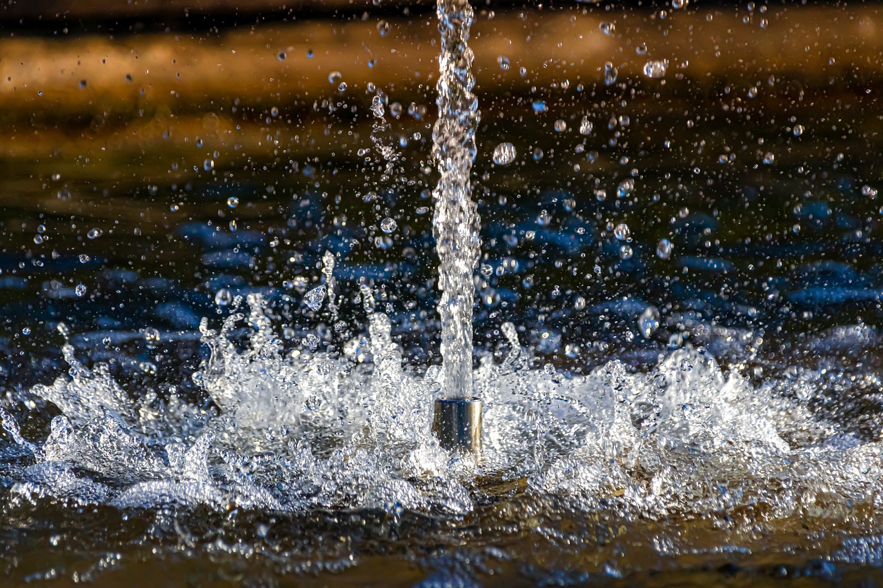 a fire hydrant spewing water into a body of water, a macro photograph, detailed hd photography, sparkling in the sunlight, high quality product image”, water splashes cascades