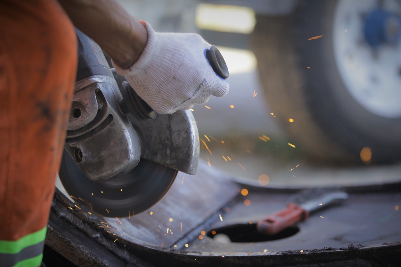 a person using a grinder on a piece of metal, by Alexander Fedosav, pexels contest winner, really realistic, banner, steel blades, (sfw) safe for work