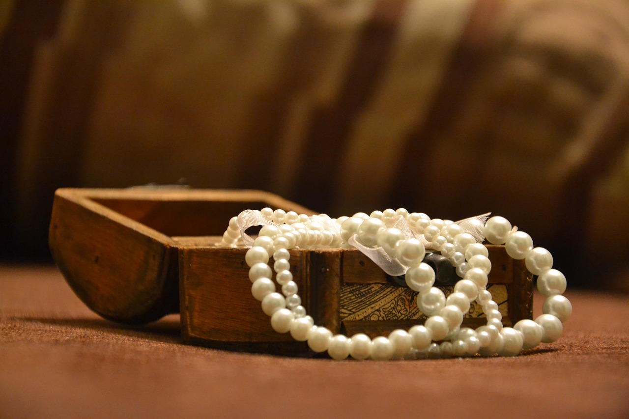 a wooden box with a bunch of pearls on it, romanticism, beautiful wallpaper, choker, taken with canon 8 0 d, white belt