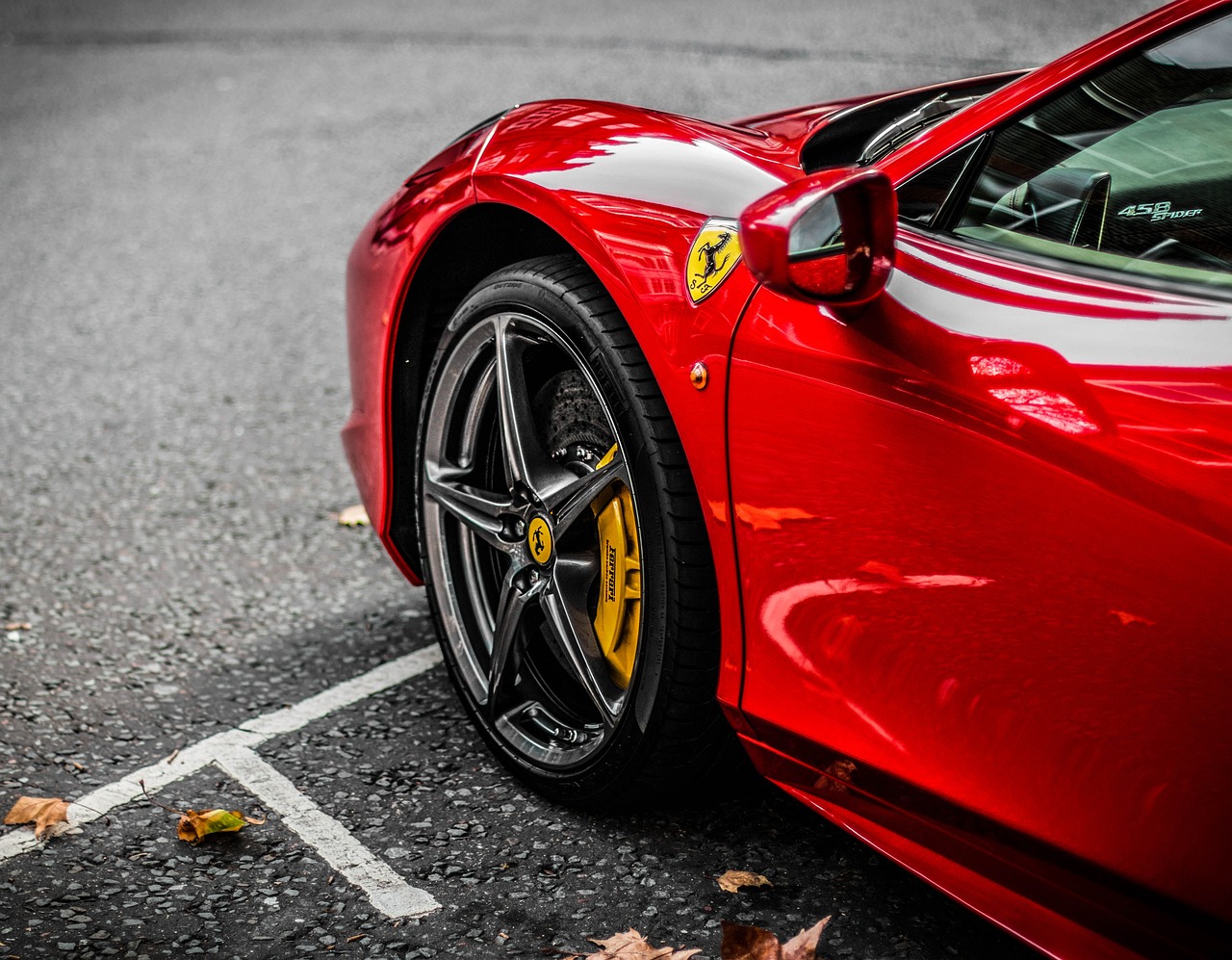 a red sports car parked in a parking lot, a photo, inspired by Bernardo Cavallino, pexels contest winner, ferrari 458, rich colour and detail, black and yellow and red scheme, 50mm close up photography