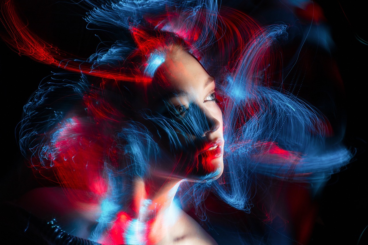 a woman with her hair blowing in the wind, by Adam Marczyński, digital art, red and blue neon, beauty shot, electric swirls, focus on generate the face