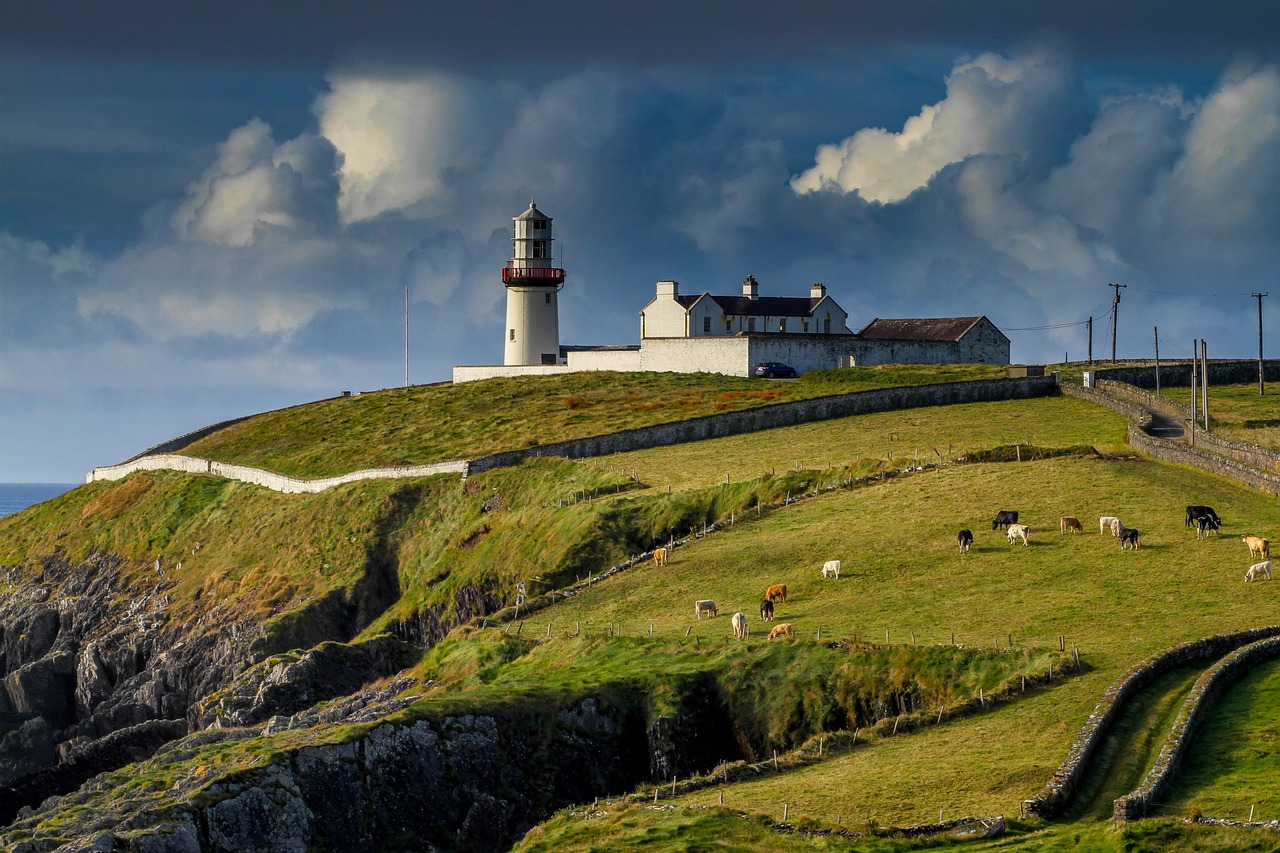 a lighthouse sitting on top of a lush green hillside, by Eamon Everall, farms, cosy, straw, daoshi