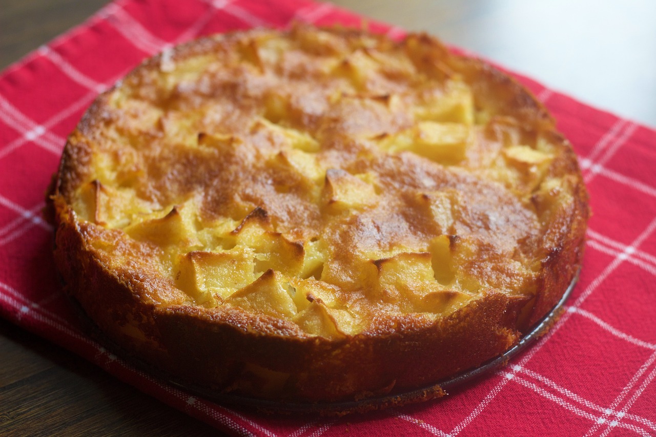 a cake sitting on top of a red napkin, inspired by Géza Dósa, yellow apples, crust, potato, rich texture