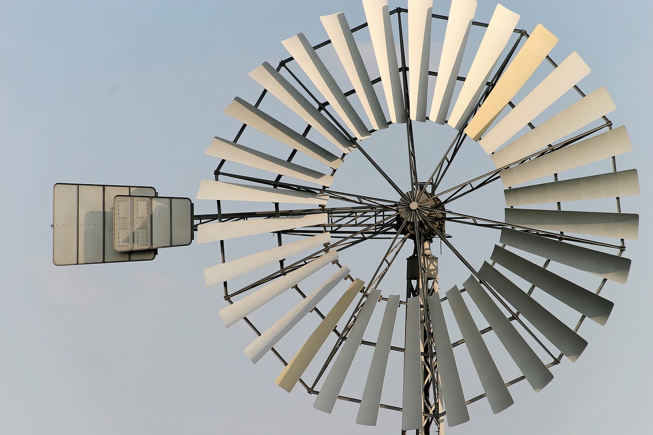 a windmill spinning in the wind on a sunny day, a portrait, by David Simpson, flickr, kinetic art, low detail, grayish, farming, 200mm wide shot