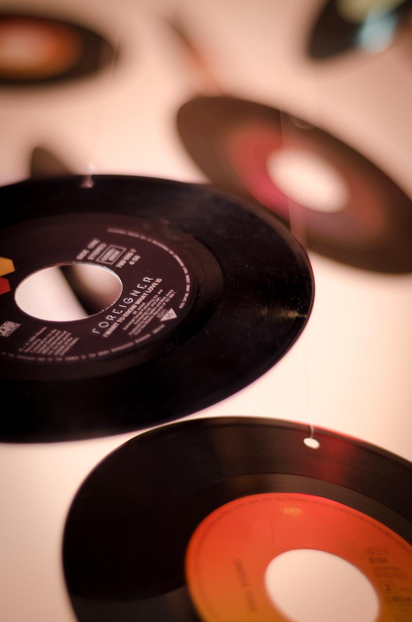 a number of old records on a table, by Etienne Delessert, unsplash, minimalism, miniature photography closeup, vertical wallpaper, toy photo, singing