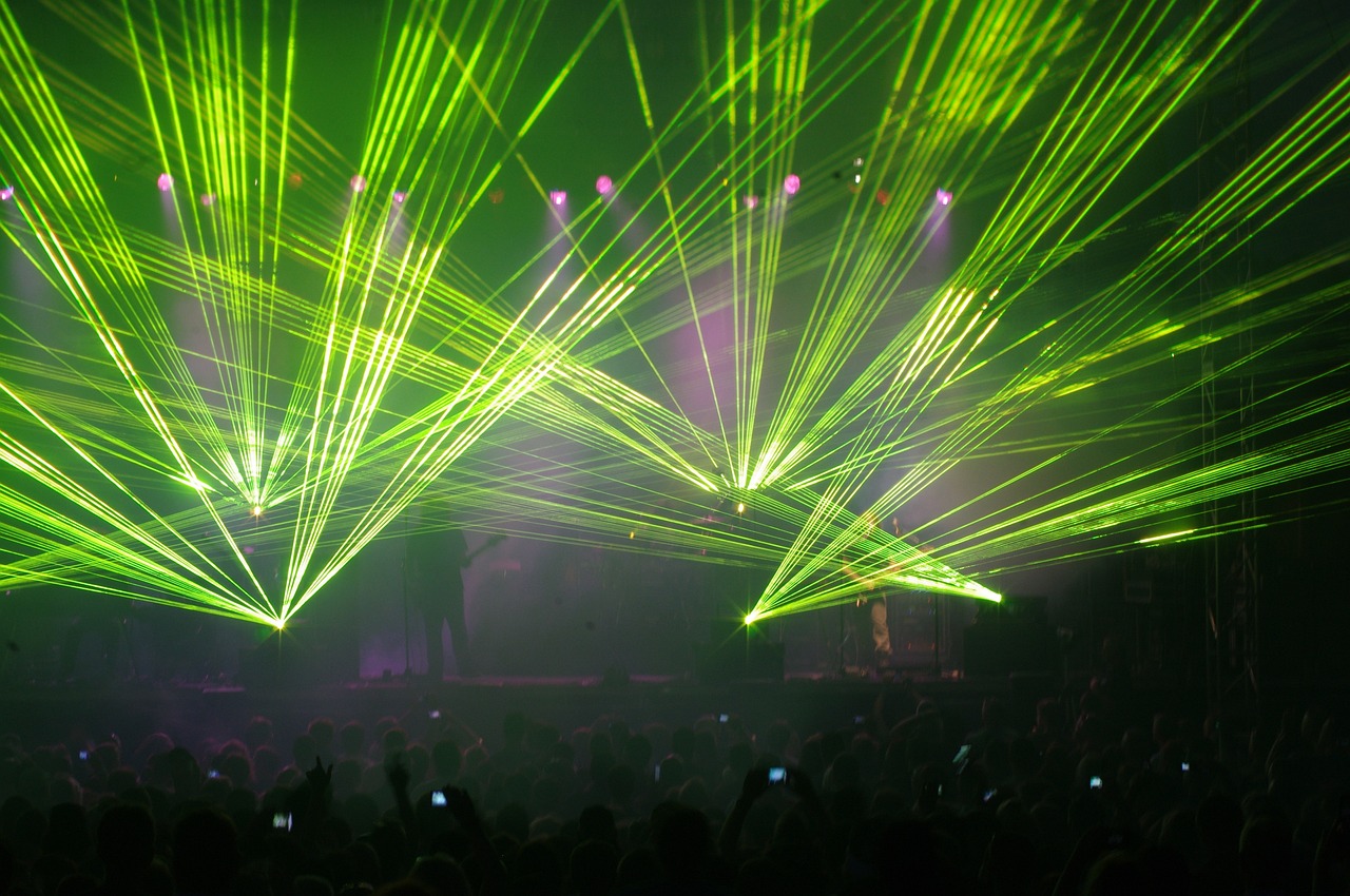 a group of people that are standing in front of a stage, rayonism, lasers for lights, live concert, gustav, watch photo