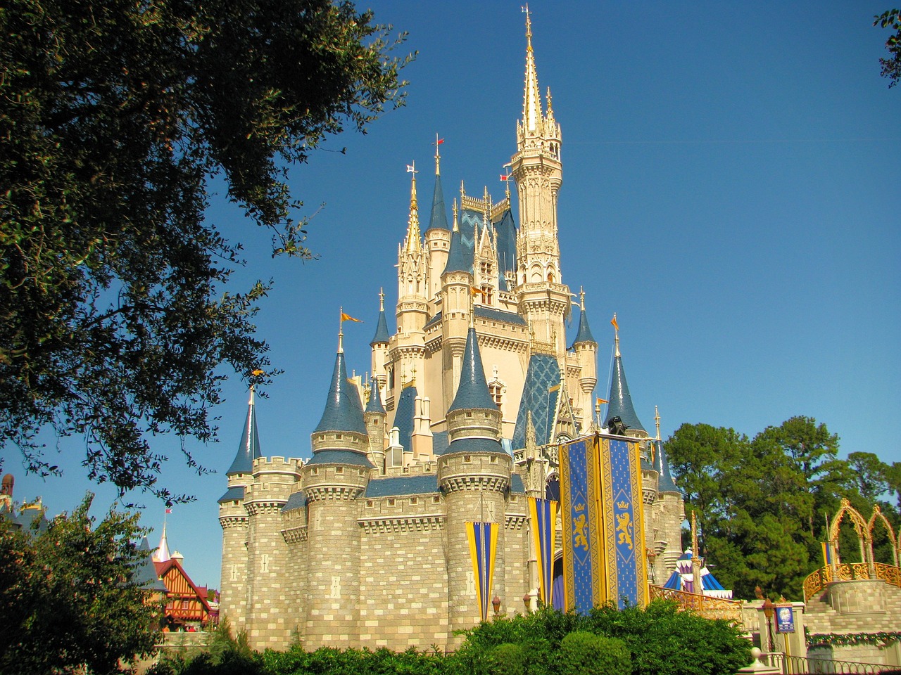 a castle sitting in the middle of a lush green park, by Walt Disney, flickr, detailed”, tall spires, beautiful”, great light and shadows”