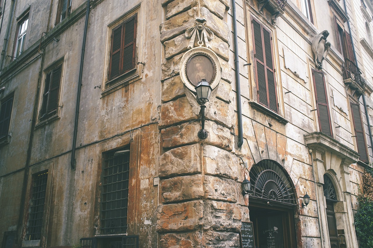 a building with a clock on the side of it, a photo, by Alessandro Allori, renaissance, under street lamp, aged and weathered, buildings carved out of stone, retro vintage and romanticism