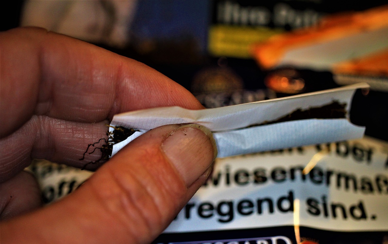 a close up of a person holding a pair of scissors, by Christen Dalsgaard, reddit, happening, taking tobacco snuff, licorice allsort filling, still in package, compressed jpeg