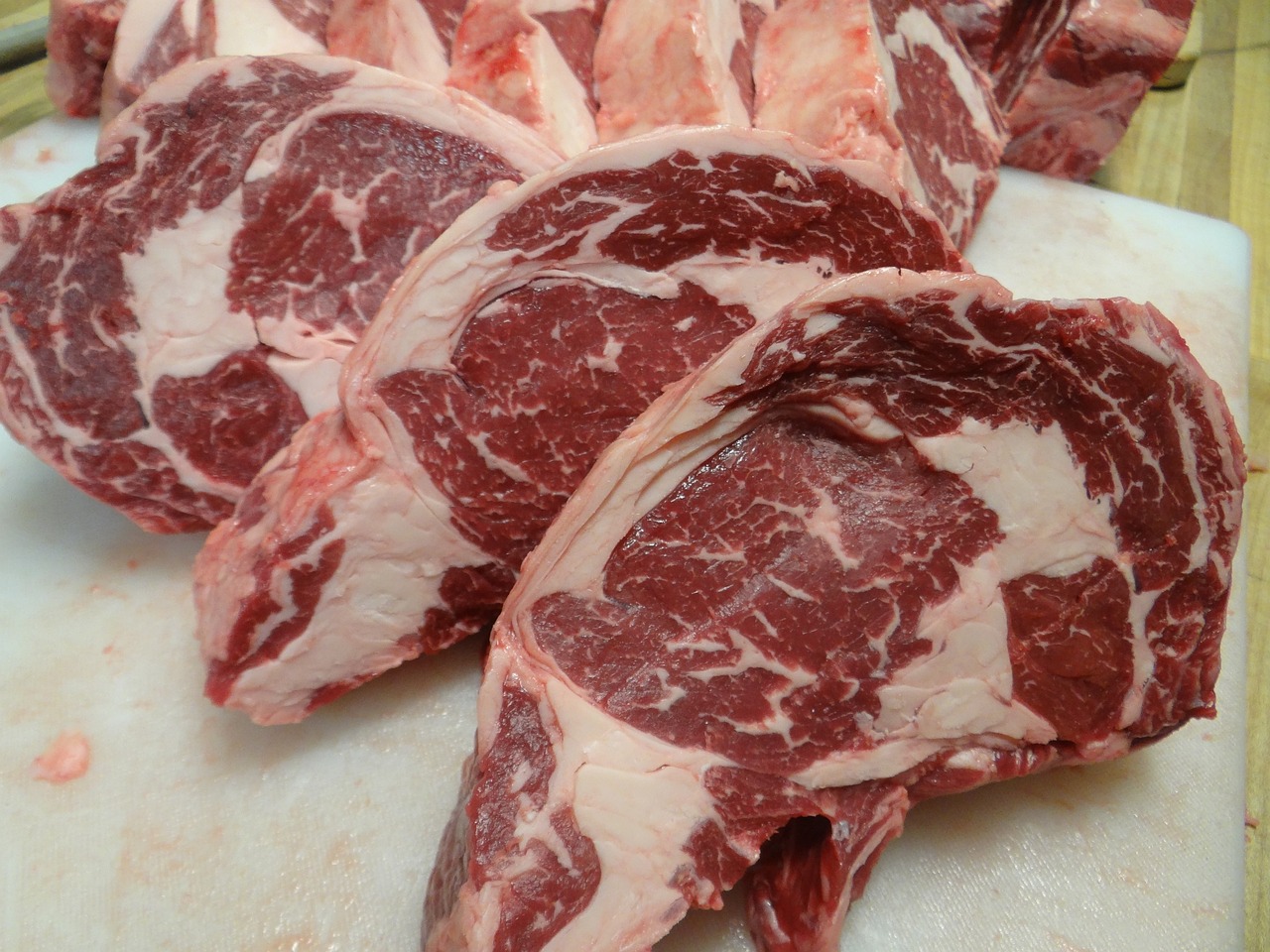 a bunch of raw meat sitting on top of a cutting board, a photo, detailed zoom photo, half goat, half body photo, illinois