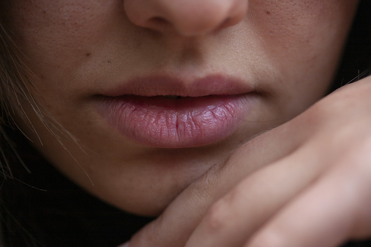 a close up of a person with a ring on her finger, by Thomas Häfner, pouty lips, bumpy mottled skin, thin light pink lips, square masculine jaw