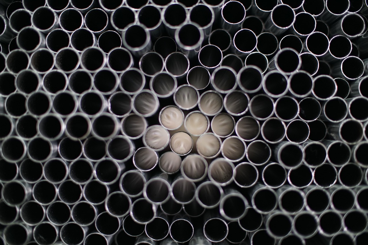 a bunch of metal pipes stacked on top of each other, by Jan Rustem, precisionism, plastic texture, microscopic photo, high quality product image”