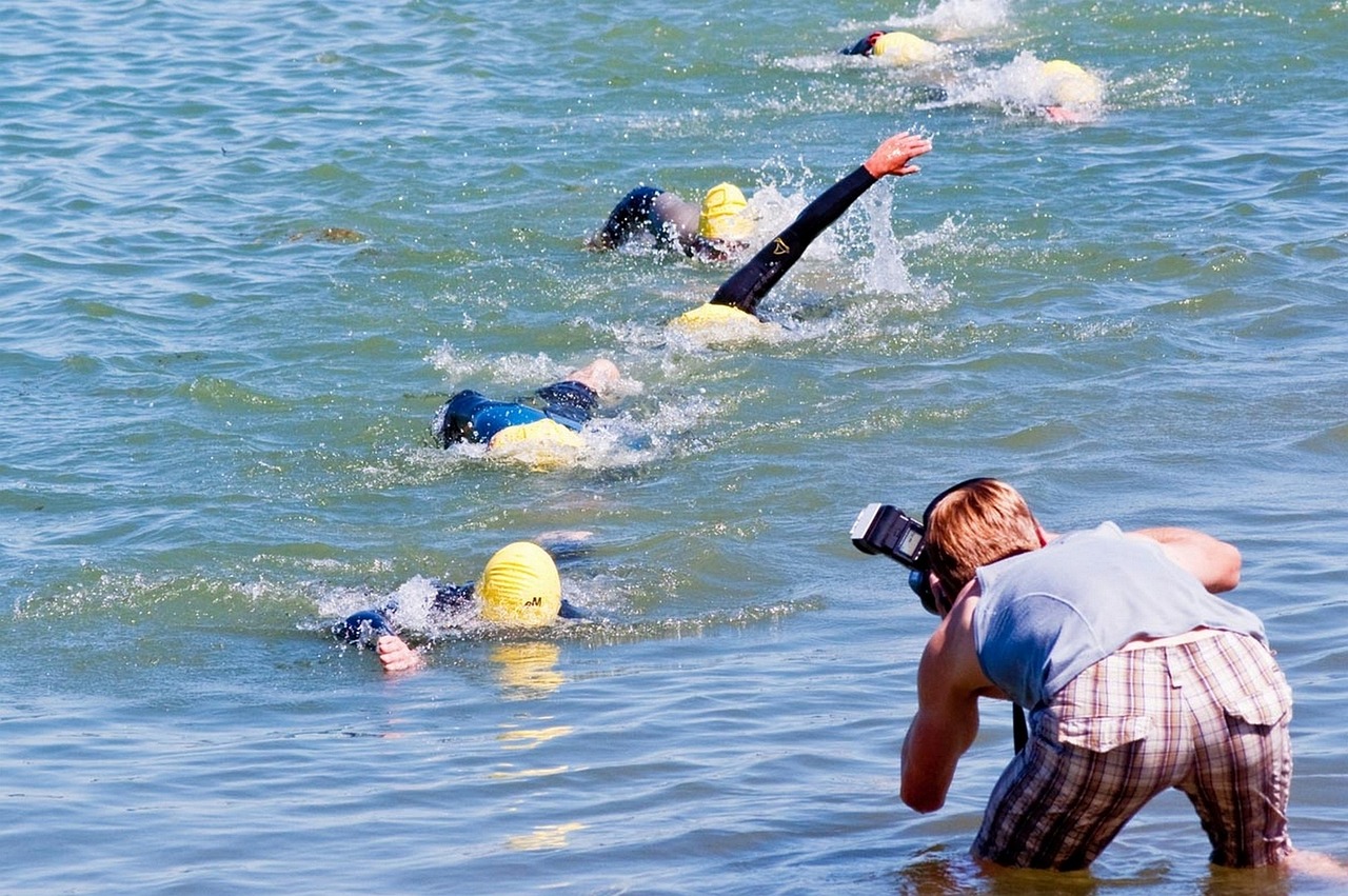a group of people swimming in a body of water, a photo, by Alison Watt, flickr, happening, with nikon cameras, ironman, tv footage, california