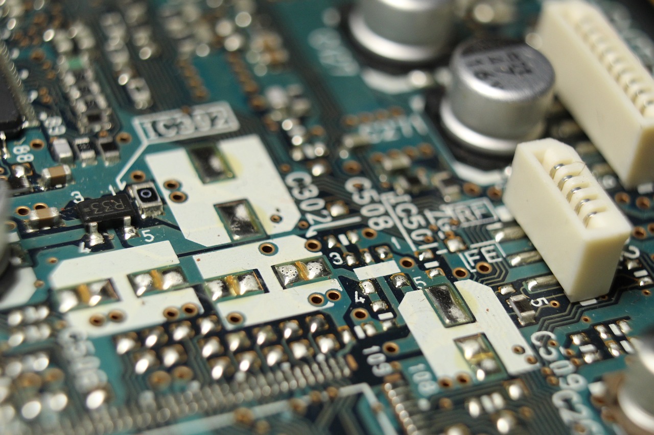 a close up of a computer mother board, by Dan Christensen, flickr, tinkercore, transistors, handheld, shenzhen