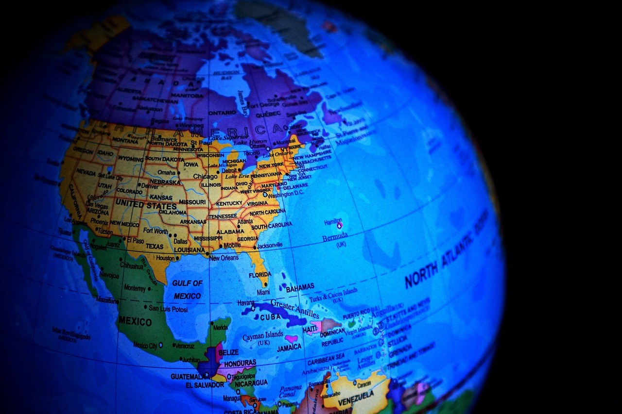 a close up of a globe with a black background, a tilt shift photo, by Sam Dillemans, fine art, puerto rico, focus on map, a brightly colored, usa-sep 20