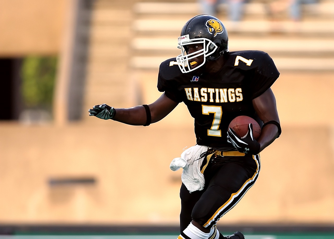 a man running with a football on a field, by David Eugene Henry, happening, dynamic action shot, gatson bussiere, late 2000’s, hawkins