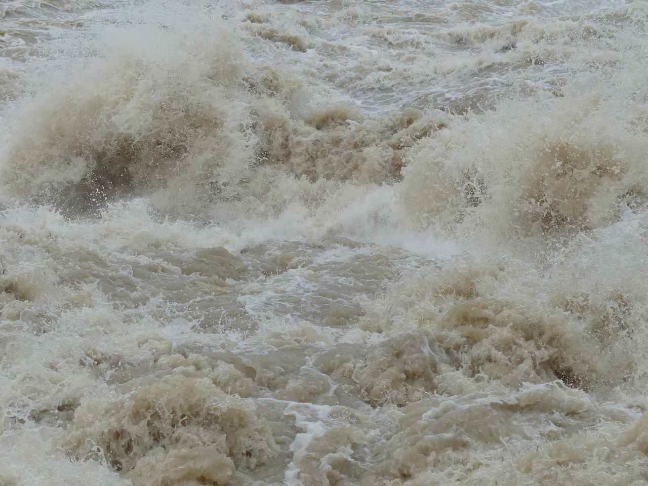 a man riding a wave on top of a surfboard, a picture, shutterstock, hurufiyya, floor flooded, thunderstorm in marrakech, detailed zoom photo, in an african river