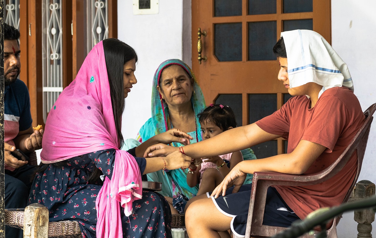 a group of people sitting on a porch, a picture, pexels, migrant mother, blessing hands, avatar image, indian