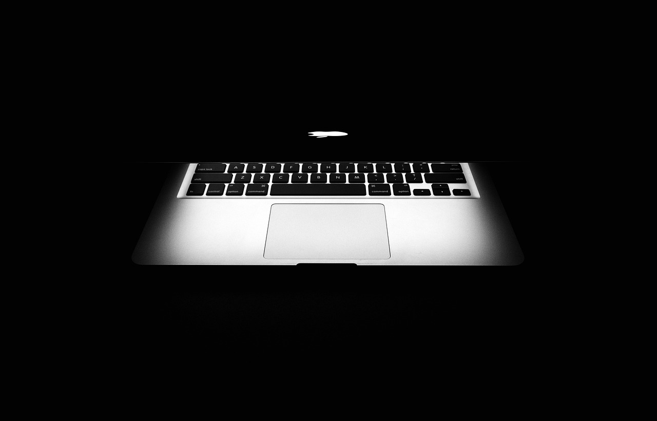 a black and white photo of a laptop, by Adam Chmielowski, unsplash, computer art, apple design, back lit lighting, mobile wallpaper, mid air shot