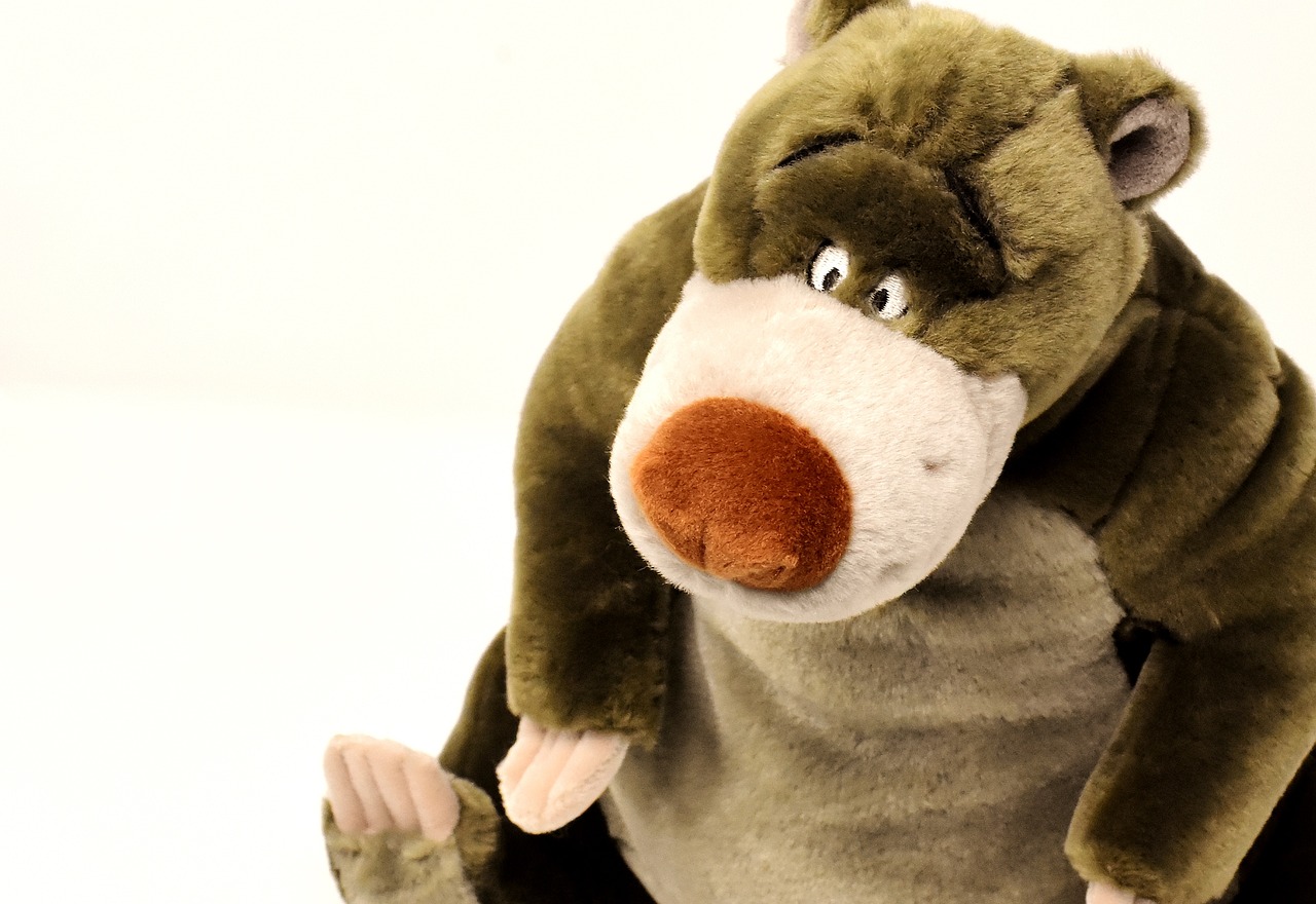 a close up of a stuffed animal on a white background, a picture, by Eero Järnefelt, flickr, disney character, hunchbacked, obese, olive