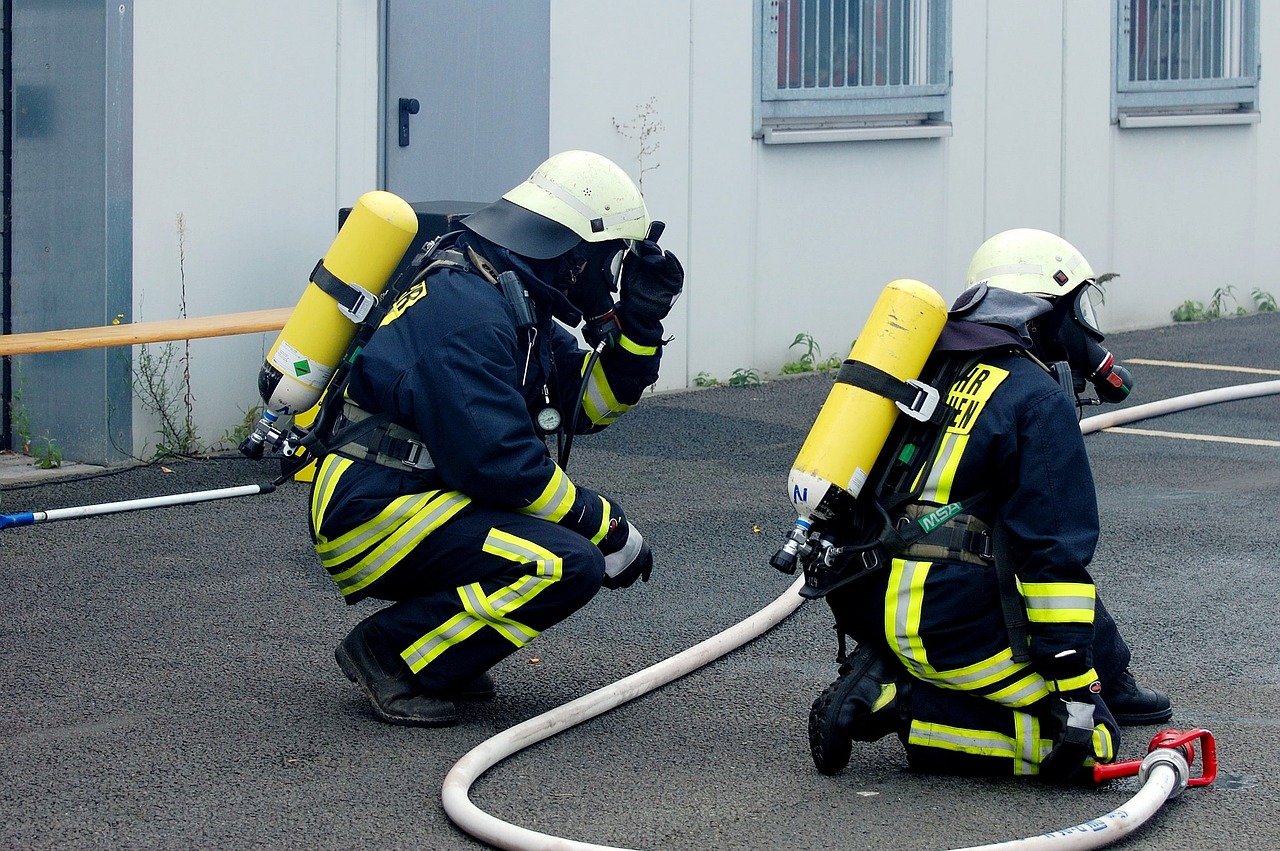 a couple of firemen standing next to each other, a photo, by Thomas Häfner, pixabay, figuration libre, oxygen mask, they are crouching, afp, video footage