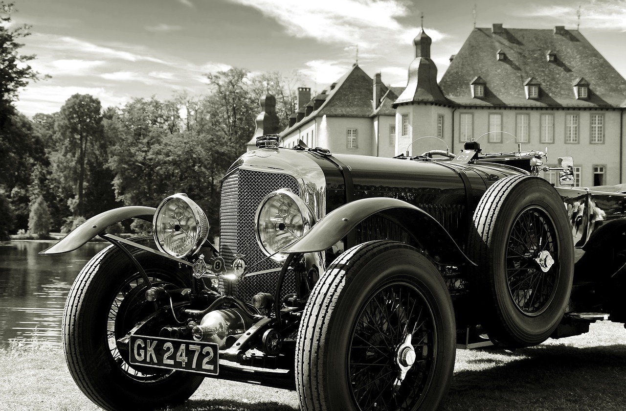 a black and white photo of a vintage car, by Hans Schwarz, pexels contest winner, baroque, bentley, sepia sunshine, breitling, historical setting