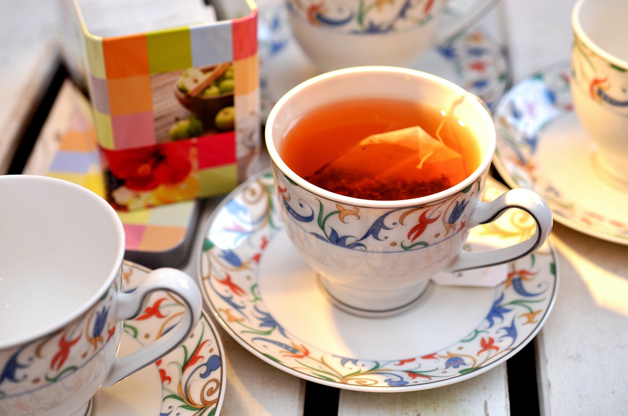 a close up of a cup of tea on a table, by Pamela Ascherson, shutterstock, dau-al-set, a brightly coloured, imari, square, exploitable image