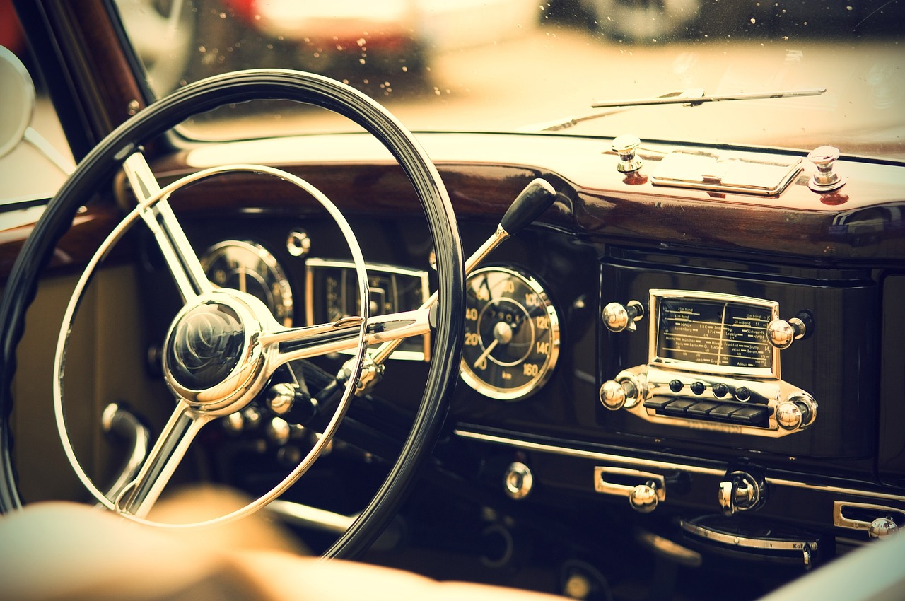 a close up of a steering wheel in a car, a picture, unsplash, retrofuturism, old timey, gorgeous background, adorable, mercedez benz