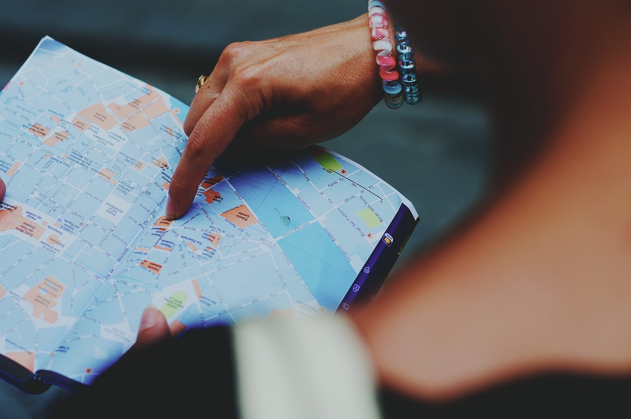 a close up of a person holding a map, by Matija Jama, pexels, happening, 🕹️ 😎 🔫 🤖 🚬, diary on her hand, oh the places you'll go, screengrab