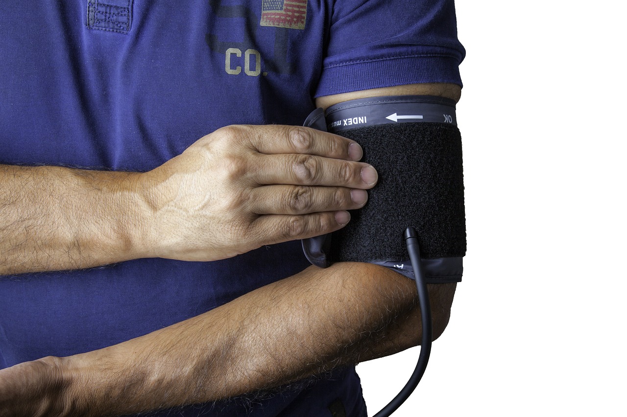 a close up of a person holding a blood pressurer, pixabay, navy, folded arms, black, 3 2 - year - old man
