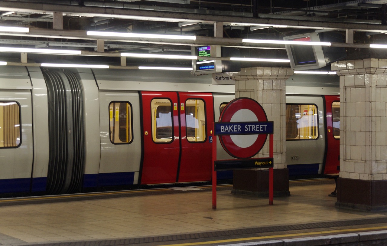 a subway train pulling into a station next to a platform, a picture, by Robert Brackman, shutterstock, union jack, oaks, 2012, finer details : 3