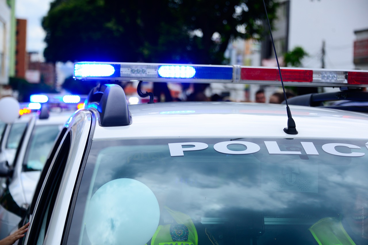 a police car parked on the side of the road, by Jeanna bauck, shutterstock, closeup photo, stock photo