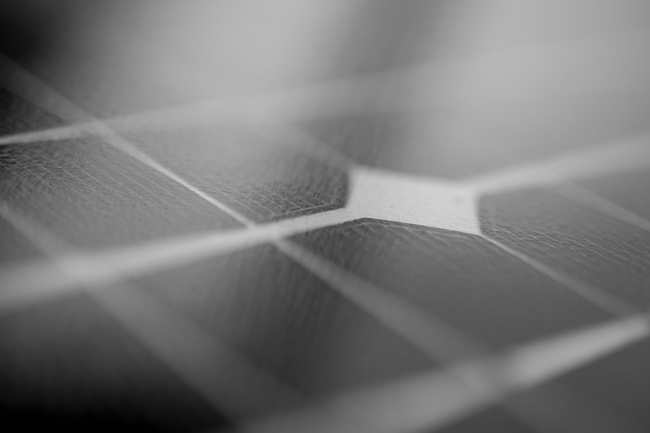 a close up of a black and white photo, a macro photograph, by Matthias Weischer, unsplash, bauhaus, solar panels, wallpaper mobile, thin dof, highly reflective surface