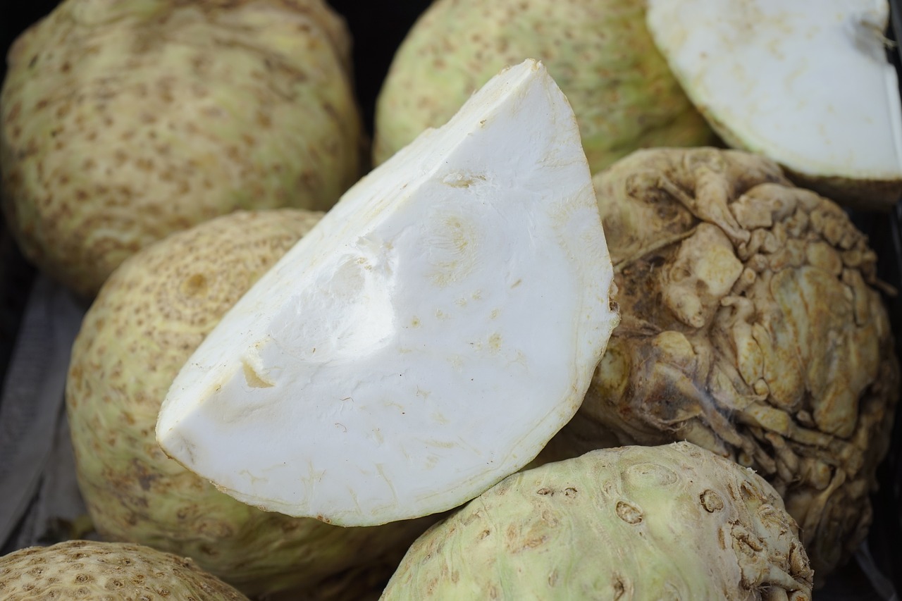 a close up of a bunch of fruit on a table, a picture, fractal ivory carved ruff, close-up product photo, coxcomb, with a whitish