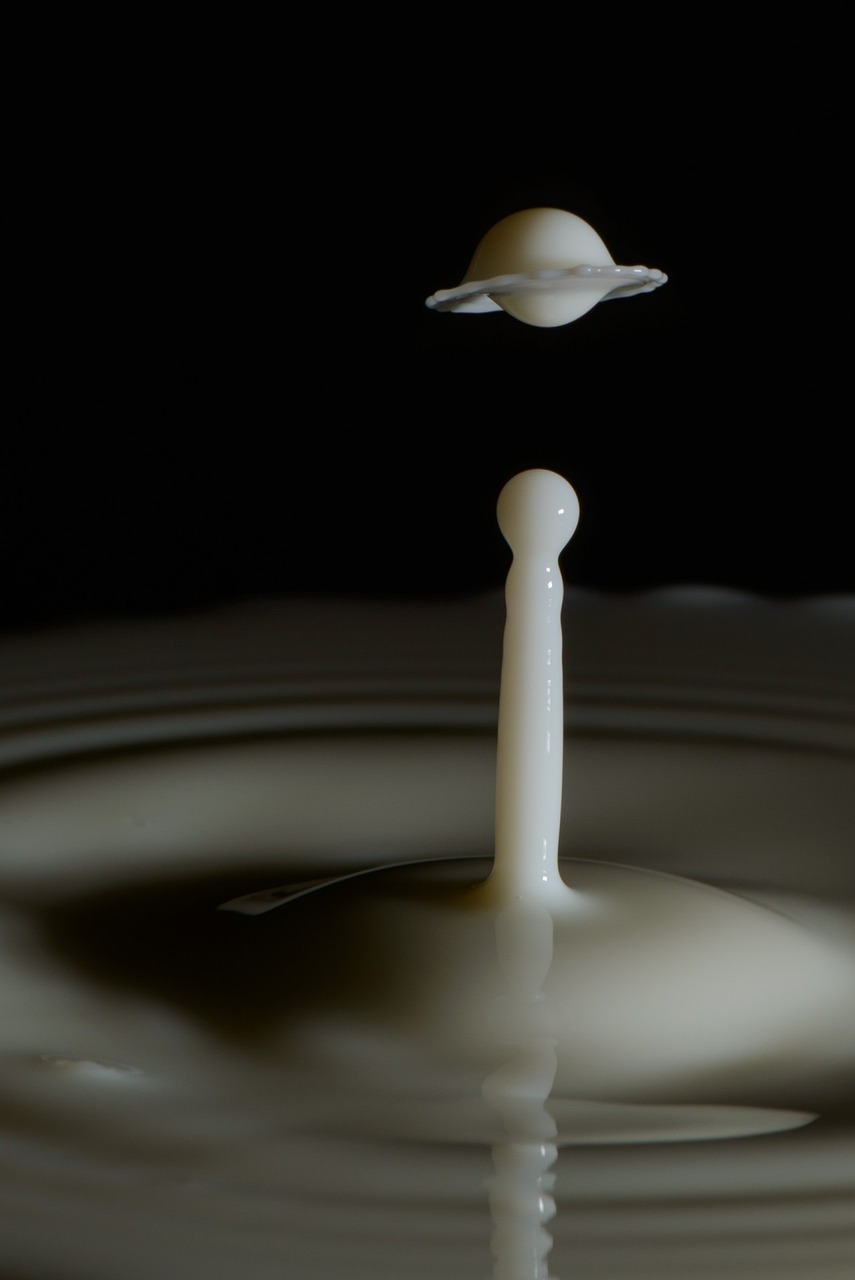 a drop of milk falling into a body of water, by Doug Ohlson, precisionism, alien abduction, visiting saturn, abstract claymation, yogurt